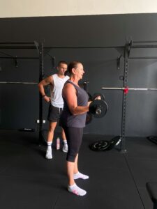 Head trainer Jacob, walking client through some bicep curls