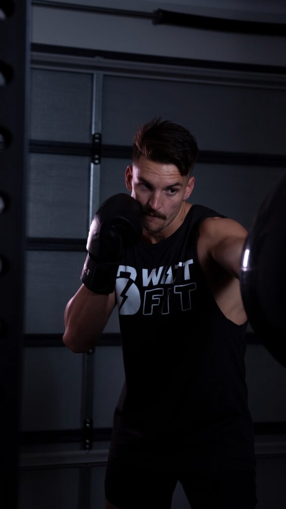 Jacob Watson punching a heavy bag